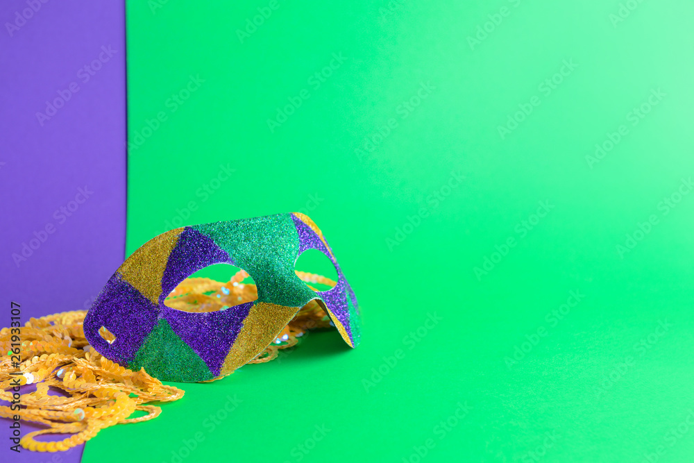 Festive mask with decor on color background