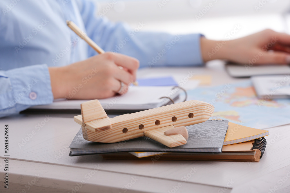 Toy airplane on table of travel agent in office
