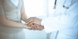 © rogerphoto - Hand of doctor reassuring her female patient. Medicine and health care concept