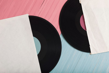 Music records on pink and blue wooden background. Retro music concept