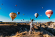 © MISHA - Couple in love among balloons. A guy proposes to a girl. Couple in love in Cappadocia. Couple in Turkey. Honeymoon in the mountains. Man and woman traveling. Flying on balloons. Wedding. Journey. Love