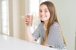 © Krakenimages.com - Beautiful young girl kid drinking fresh tasty chocolate milkshake as snack with a happy face standing and smiling with a confident smile showing teeth