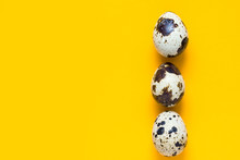 Vertical Row Of Speckled Quail Eggs On Bright Yellow Background. Easter Greeting Card Poster Banner Streamer Placeholder Template. Creative Minimalist Conceptual Style