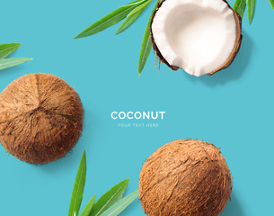 Wall Mural - Creative layout made of coconut. Flat lay. Food concept. Macro concept. Blue background.