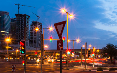 Colorful Traffic Signal lights in Dubai City beautiful night view of Dubai Metro station and buildings blue sky with street lights