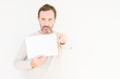 © Krakenimages.com - Senior man holding blank paper sheet over isolated background pointing with finger to the camera and to you, hand sign, positive and confident gesture from the front