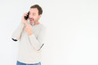 © Krakenimages.com - Senior man talking on smartphone over isolated background very happy pointing with hand and finger