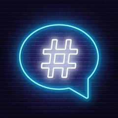 Neon hashtag sign in speech bubble on brick wall background. Vector illustration.