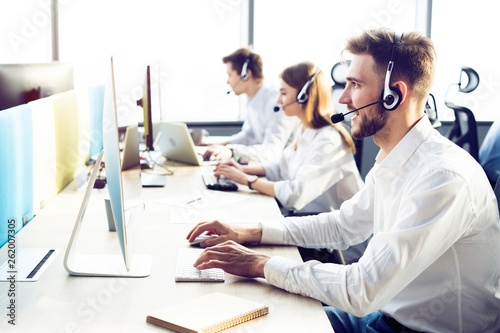 Cuadros en Lienzo Happy young male customer support executive working in office.