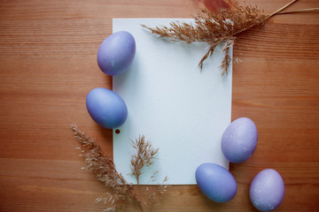 Easter purple egg with branches of wheat and a white sheet to record