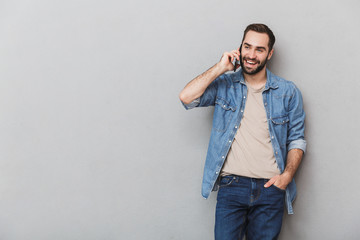 Wall Mural - Excited cheerful man wearing shirt standing isolated