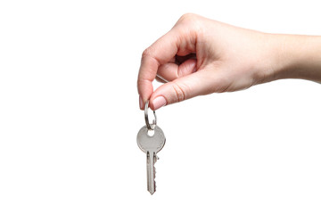 Female hand holding house key on white background