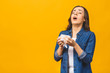 © denis_vermenko - Portrait of young woman coughing with a napkin, catch cold, feeling ill, yellow studio background, isolated.