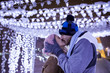 © Westend61 - Happy young couple kissing in winter decoration