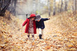 © natalialeb - boy and girl in hats walk in park, autumn mood