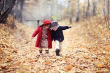 Boy And Girl In Hats Walk In Park, Autumn Mood
