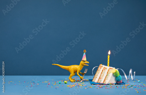 Foto  Yellow Dinosaur Eating Birthday Cake Slice over Blue Background