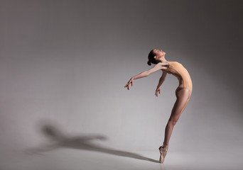 young beautiful ballet dancer in beige swimsuit