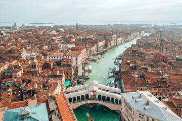 Wall Mural - aerial panoramic view of famous canal grande and famous rialto bridge at sunset in venice, italy.
