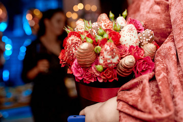 a bouquet of strawberries in chocolate and roses