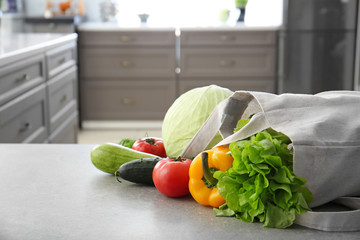 Wall Mural - Eco bag with fresh vegetables on table in kitchen