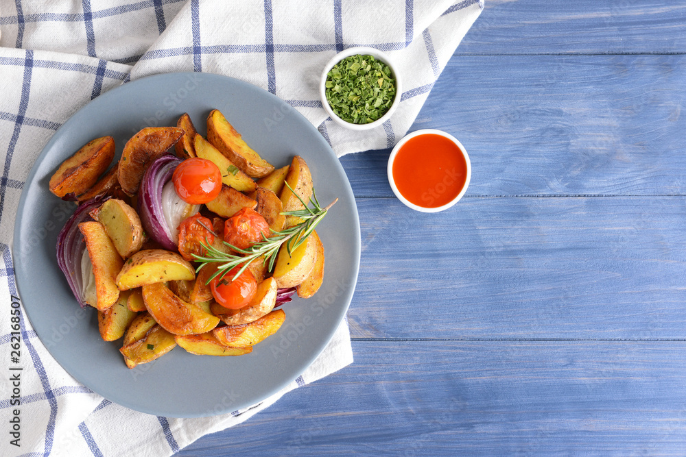 Plate with tasty baked potato on table