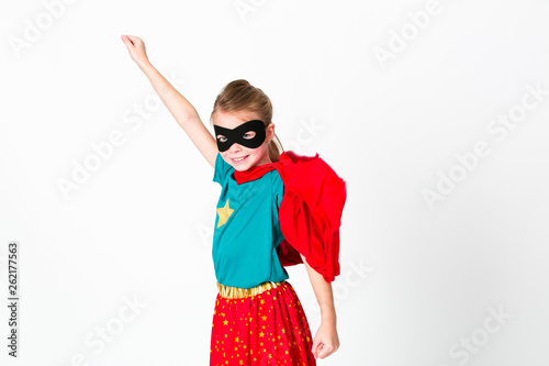 blond supergirl with black mask and red cape posing in front of white background Tableau sur Toile