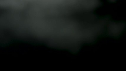 Poster - Isolated white fog on black background, smoky effect. Stock footage. Blurred smoke clouds overlay on black background.