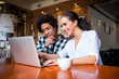 © leszekglasner - Multiethnic people meeting at cafe, advisor showing offer to client on laptop