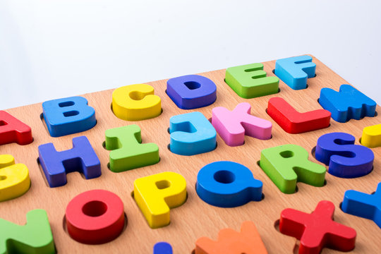 Colorful letter blocks on board on white