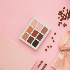 Wall Mural - Women's dress, makeup shadows, diary and scattered coffee on a powdery pink background, flatlay, copyspase, closeup