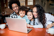 © leszekglasner - Happy multiethnic family having fun while using laptop together