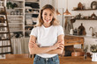 © Drobot Dean - Portrait of pretty blond woman smiling and rejoicing while standing in stylish wooden kitchen at home