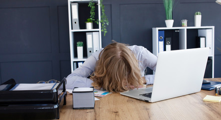 Young frustrated exhausted woman laid her head down on the table sit work at white desk with contemporary pc laptop. Achievement business career concept