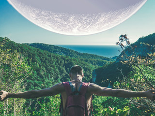 Wall Mural - traveling young man and huge planet in the sky b