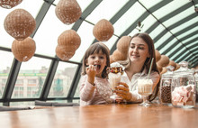 Happy Young Women Mother With Children Drinking A Milkshake