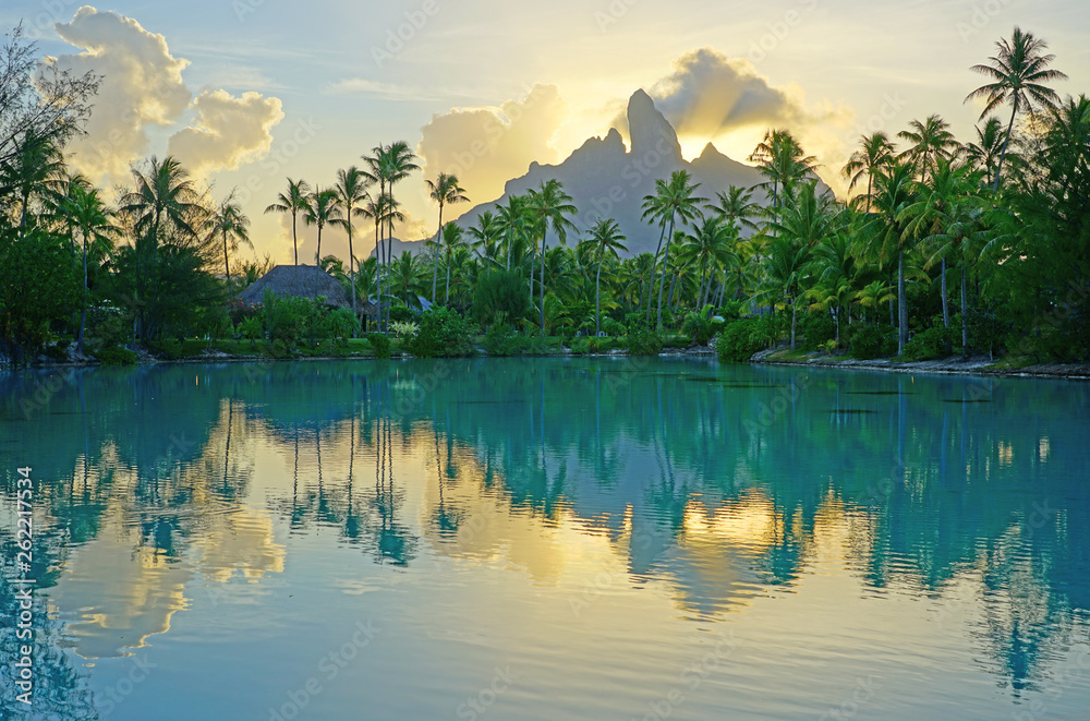View of the Mont Otemanu mountain reflecting in water at sunset in Bora Bora, French Polynesia, South Pacific - obrazy, fototapety, plakaty 