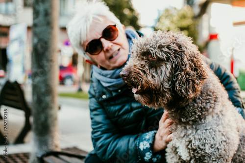 Middle Aged Woman With White Hair Enjoying Her Spanish Spaniel By