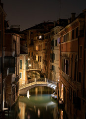 Wall Mural - View into a small canal in Venice by night