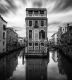 Fototapeta Londyn - View of a beautiful house in Venice, which stands in the middle of the canal. Black and white 