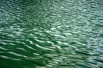 Abstract background of wave on the surface, river surface with sun light reflected on water skin, Smooth liquid surface and shadow of clouds sky, Ripple of wave flow on river