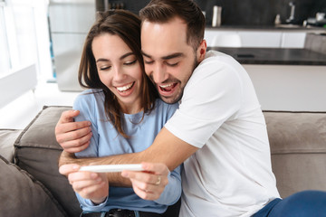 Wall Mural - lovely young couple holdingpregnancy test