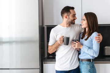 Wall Mural - beautiful young couple drinking coffee