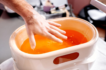 Manicure treatment with a paraffin bath tub