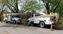 Parked Emergency Utility Vehicles On Neighborhood Residential Street After Storm.