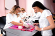 © didesign - Attractive young woman choosing a perfect color for her nails