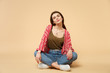 © ViDi Studio - Portrait of tender pretty young woman in casual clothes sitting, looking camera isolated on pastel beige wall background in studio. People sincere emotions, lifestyle concept. Mock up copy space.