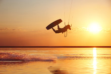 Kitesurfer At Sunset With Jump