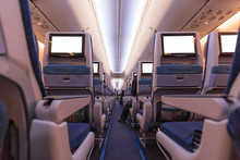 Comfortable Seats In Cabin Of Aircraft With Screens In Chairs Back