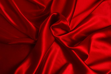 Red silk or satin luxury fabric texture can use as abstract background. Top view.